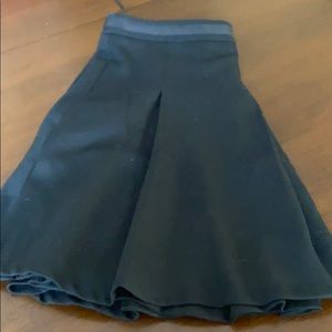 Will be donated 10/01. 
NWOT black pleated a-line skirt.